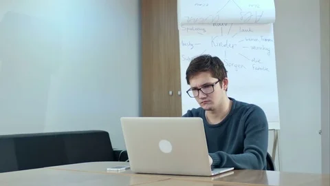 Concentrated young man using laptop in class room 스톡 동영상 77509353