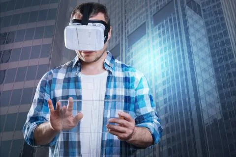 Concentrated young man in virtual reality glasses Stock Photos