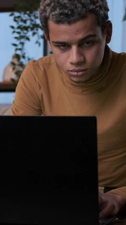 Concentrated Young Man Working on a Laptop at Night Stock Footage 326118665