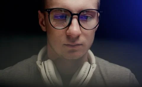 Concentrated young professional programmer in computer glasses with monitors Stock Photos