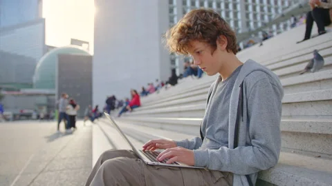 Concentrated young programmer freelancer looking at laptop screen, working Stock Footage 220552236