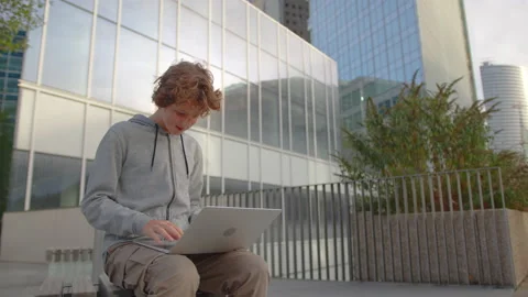 Concentrated young programmer freelancer looking at laptop screen, working Stock Footage 221186429