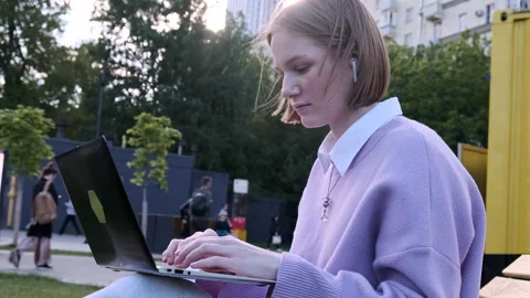 Concentrated young woman freelancer in wireless headphones Stock Footage 156775813