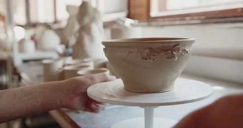 Concentrated young woman using modeling tool while making clay cup Stock Footage 207069827