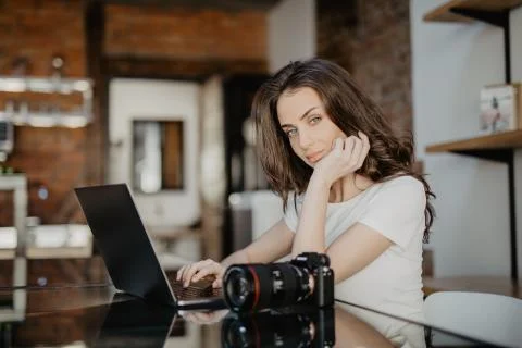 Concentrated young woman watching tutorial online on modern laptop device usi 스톡 사진