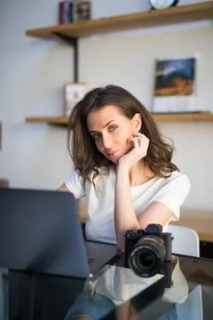 Concentrated young woman watching tutorial online on modern laptop device usi Stock Photos