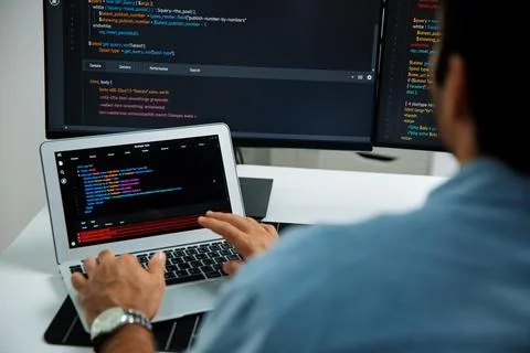 Concentrating IT working software development coding on laptop and pc. Surmise. 스톡 사진