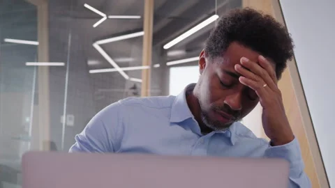 Concentrating on a laptop, solving a problem in a modern office. Stock Footage 308007649