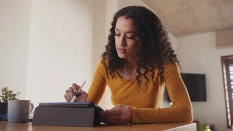 Concentrating Multicultural female typing on electronic tablet, working remotely Stock Footage 168226494