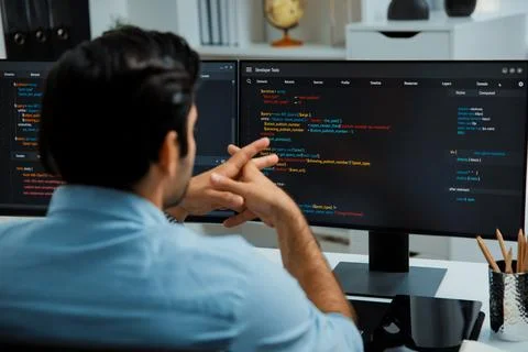 Concentrating in smart IT developer working coding on two pc screen. Surmise. 写真素材