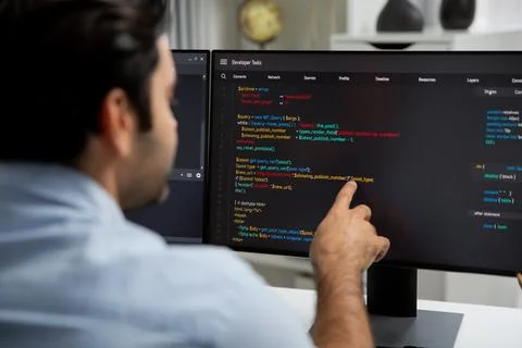 Concentrating in smart IT developer working coding on two pc screen. Surmise. 스톡 사진