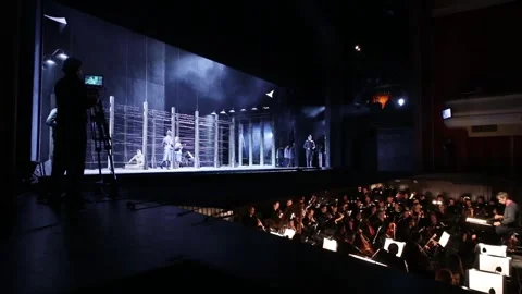Concentration camp on stage and orchestra pit at Stock Footage 299649534