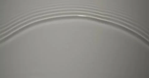 Concentric circles spread out on calm water 4K Stock Footage 339330653