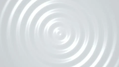 Concentric circular ripples expand on a smooth white liquid surface Stock Footage 340877160