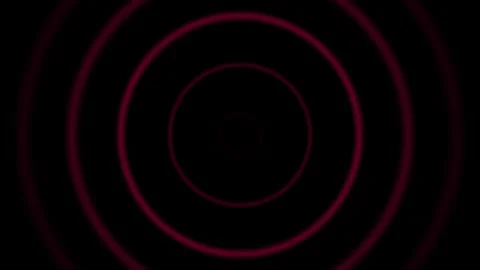 Concentric red circles radiating outward against a deep black background Video stock 335117649