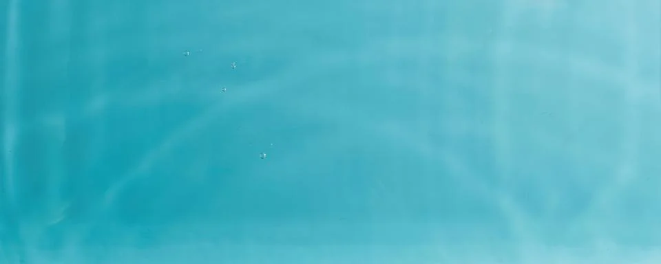 Concentric water waves interference pattern on turquoise fluid surface Stock Photos