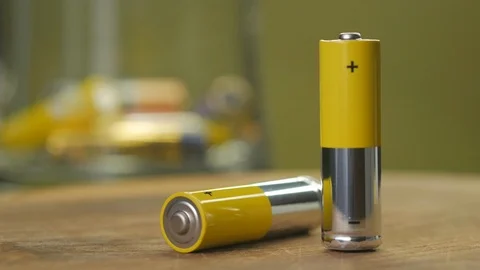 The concept of AA batteries on the table Stock Footage 123630569