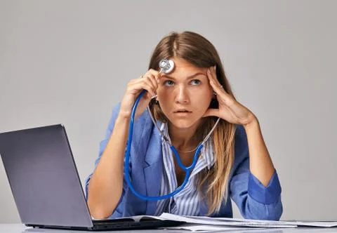 Concept about problems at work. A female worker, looking upwards, listens to Stock Photos