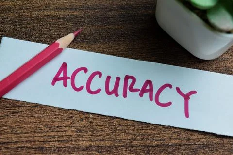 Concept of Accuracy write on sticky notes isolated on Wooden Table. Stock Photos
