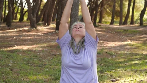 Concept of active life in middle age. Mature woman in sporty outfit relaxing Stock Footage 221197441