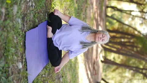 Concept of active life in middle age. Mature healthy woman with gray hair doing Stock Footage 237440636