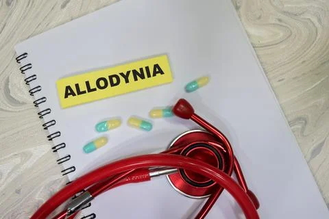 Concept of Allodynia write on sticky notes isolated on Wooden Table. 库存照片