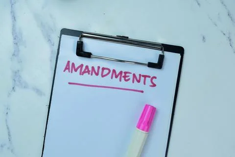 Concept of Amandments write on paperwork isolated on Wooden Table. Fotos de archivo
