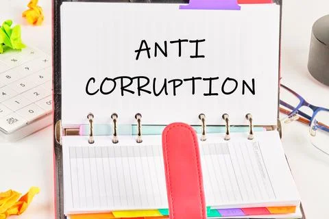 Concept of Anti Corruption written in an open notebook on a white background Stock Photos