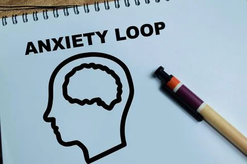 Concept of anxiety loop write on book isolated on Wooden Table. Stock Photos