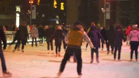 Concept Apprentice Training. Crowd at Night City Skating Rink. Falling Snow. Stock Footage 70408042