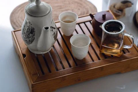 The concept of an Asian tea set with a white tea set of cups and a teapot with Stock Photos