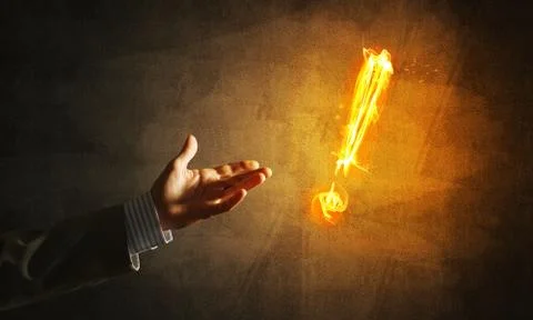 Concept of attention or punctuation with burning exclamation mark on dark Foto stock