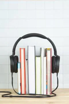 Concept of audio book. headphone and books on white background 写真素材