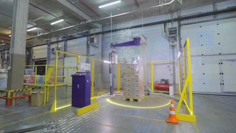The concept of automatic packaging of goods in film. Packing boxes in film at Stock Footage 251522936