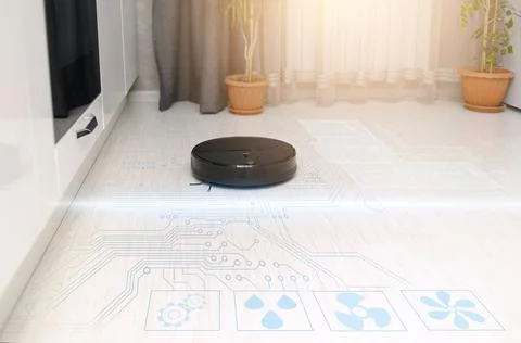 The concept of automation of the cleaning process with a robot vacuum cleaner Stock Photos