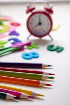 Concept back to school. Alarm clock and School supplies. Top View Flat Lay Stock Photos