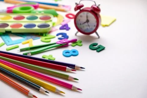 Concept back to school. Alarm clock and School supplies. Top View Flat Lay Stock Photos