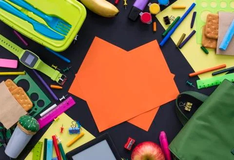 Concept back to school apple backpack stationery on black background. Stock Photos