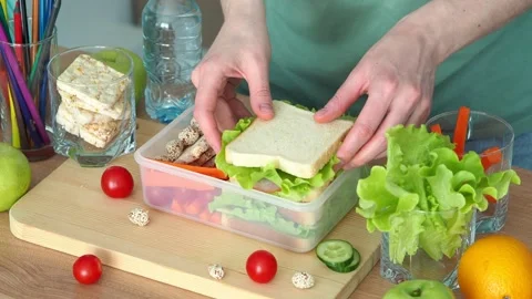 The concept of Back to School. To pack a lunch box for school. School lunch. A h Stock Footage 240317451