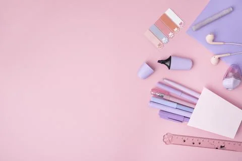 The concept of Back to School. School or office stationery purple on a pink b Stock Photos