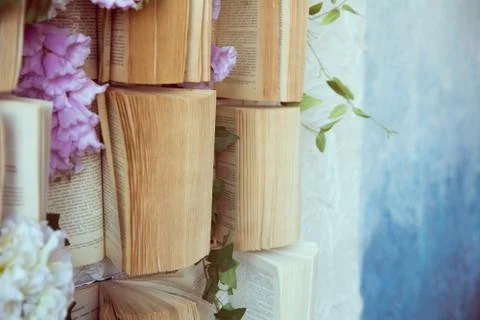 Concept background opened books on the wall and flowers of artificial purple  스톡 사진
