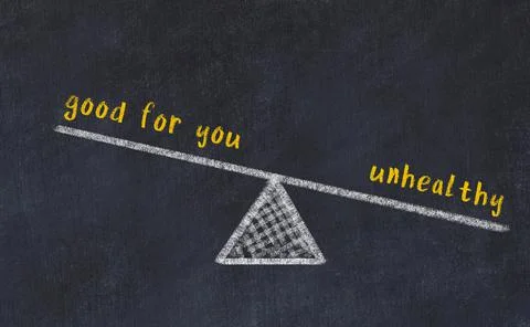 Concept of balance between good for you and unhealthy. Black chalboard with s 写真素材