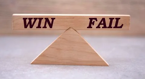 Concept of the balance of words between win and failure on wooden scales on a Stock Photos