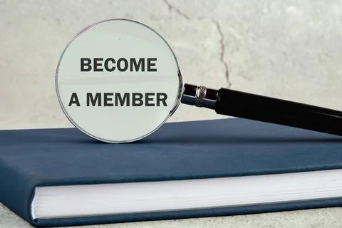 Concept. Become a member text through a magnifying glass located on a busines Stock Photos