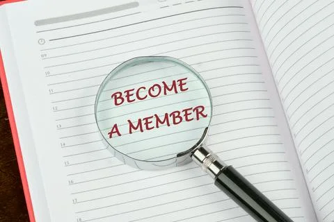 Concept. Become a member text through a magnifying glass on a notepad page Stock Photos