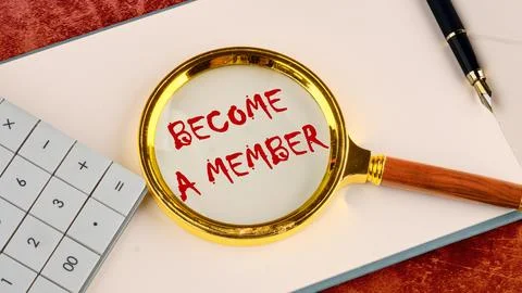 Concept. Become a member text through a magnifying glass in red provocative l Stock Photos