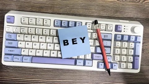 Concept of BEY write on sticky notes isolated on Wooden Table. Fotos de archivo