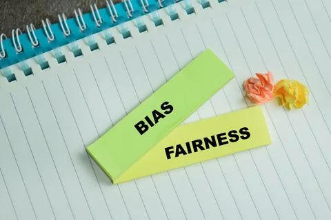 Concept of bias and fairness write on sticky notes isolated on Wooden Table. Stock Photos