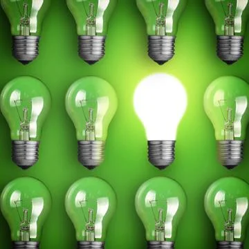 Concept for big idea. glowing light bulb on green background Stock Photos