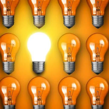 Concept for big idea. glowing light bulb on orange background Stock Photos